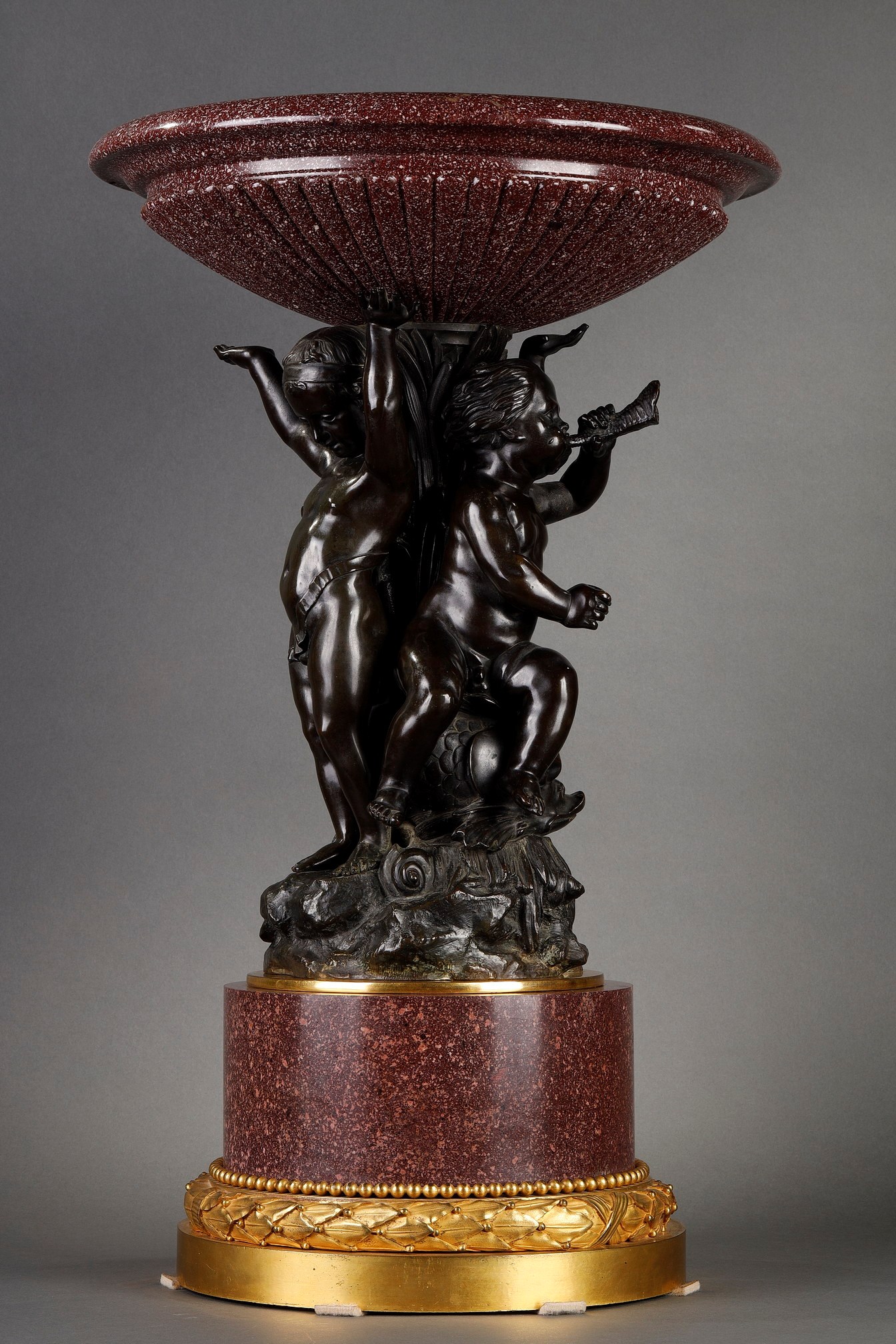 Early 19th century red porphyry centrepiece with putti in patinated bronze